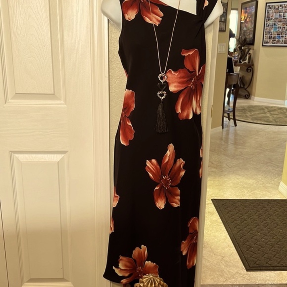 A black crepe hi/Lo dress with maroon magnolias and cut in shoulder. A beauty 🌺